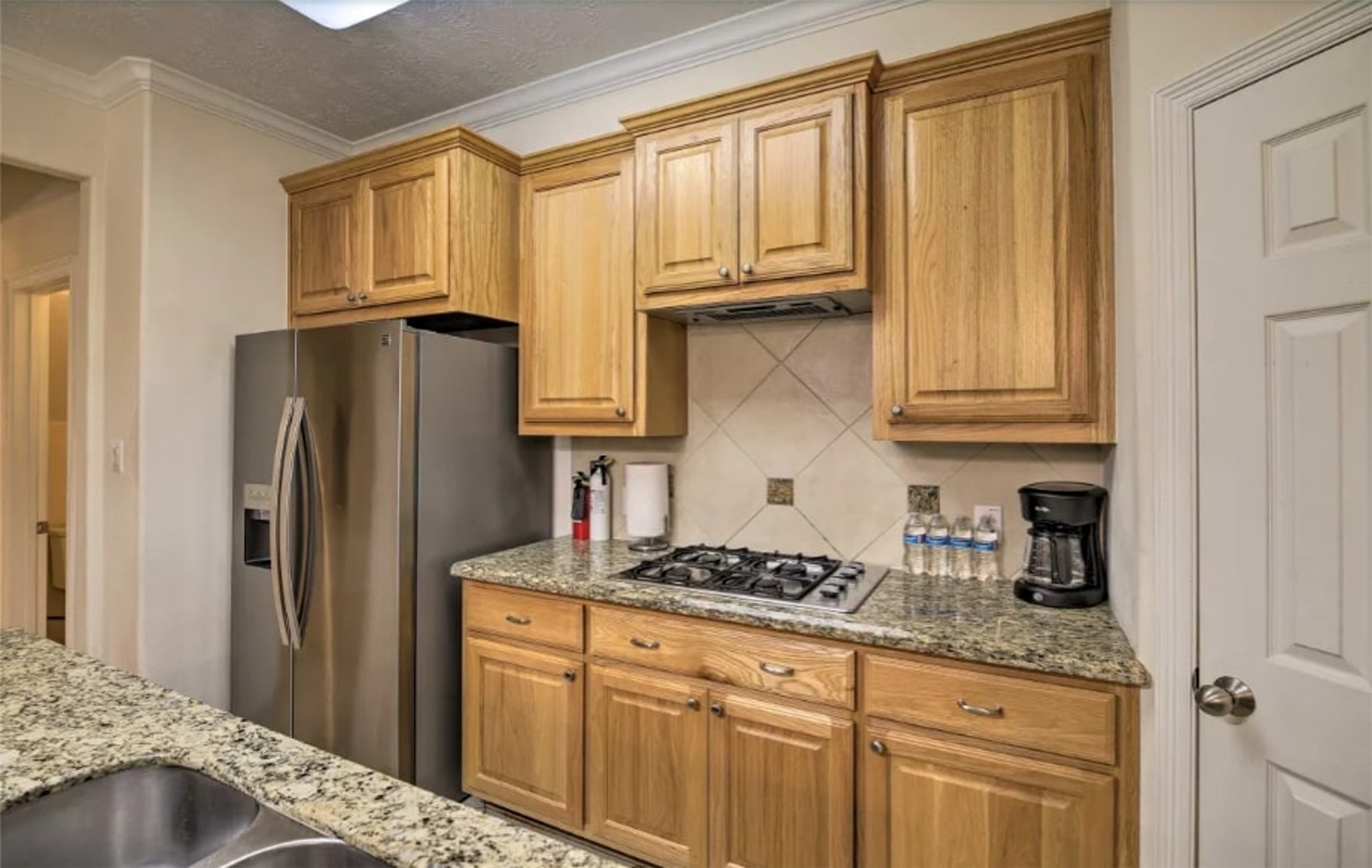 1006 Rochow Street, Unit A Houston, TX 77019 - Photo 8 of 29 a kitchen with stainless steel appliances granite countertop a refrigerator sink and cabinets