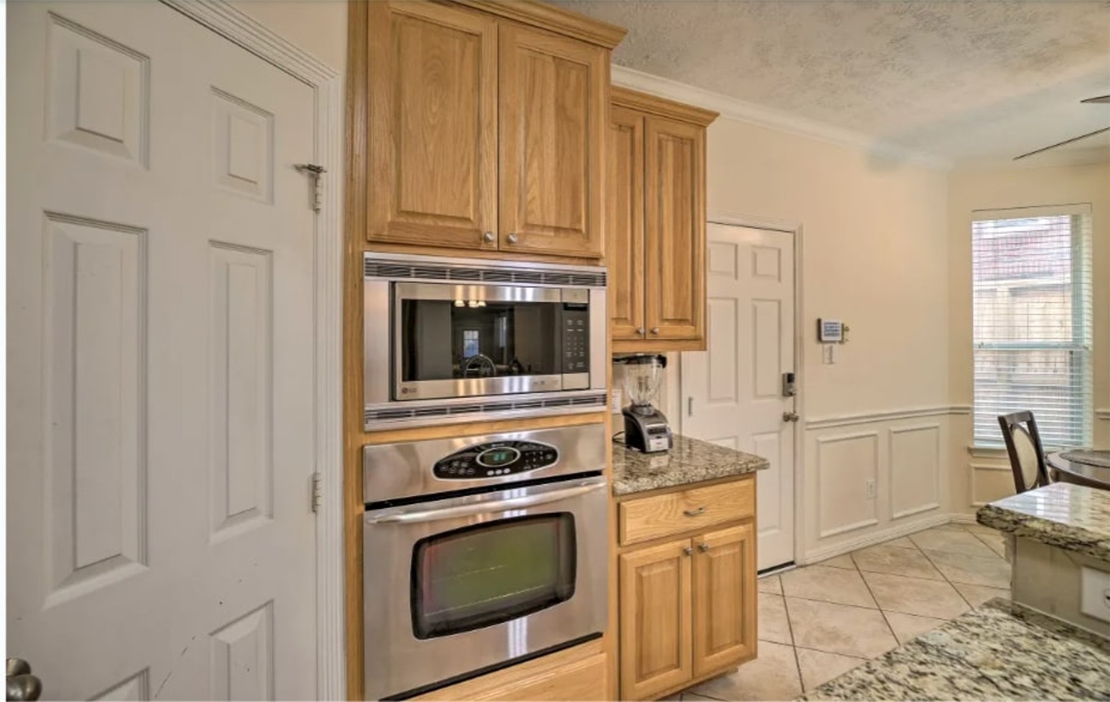 1006 Rochow Street, Unit A Houston, TX 77019 - Photo 9 of 29 a kitchen with white cabinets and white appliances