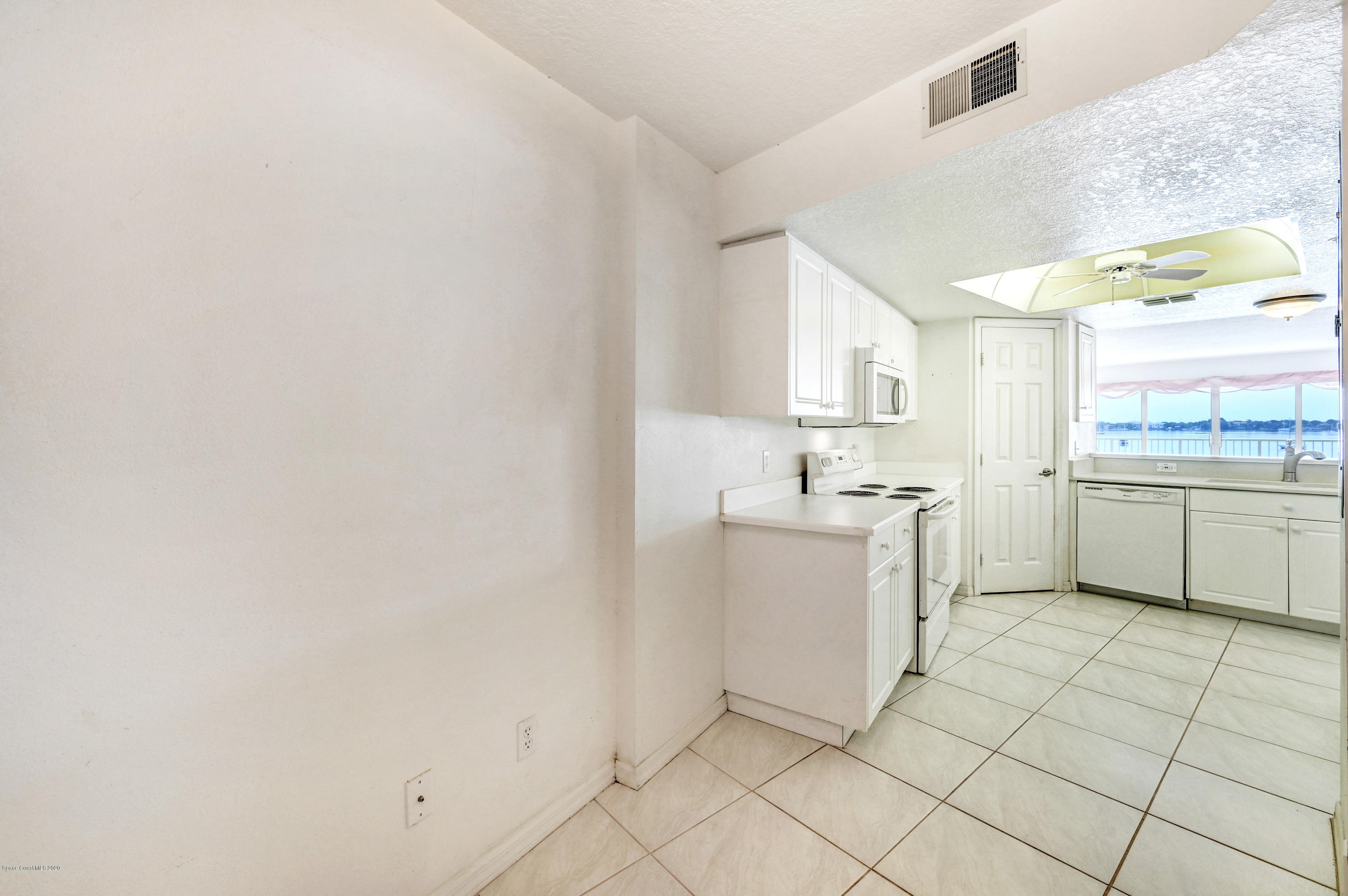 102 Riverside Drive, Unit 304 Cocoa, FL 32922 - Photo 13 of 49 a kitchen with a sink cabinets and window