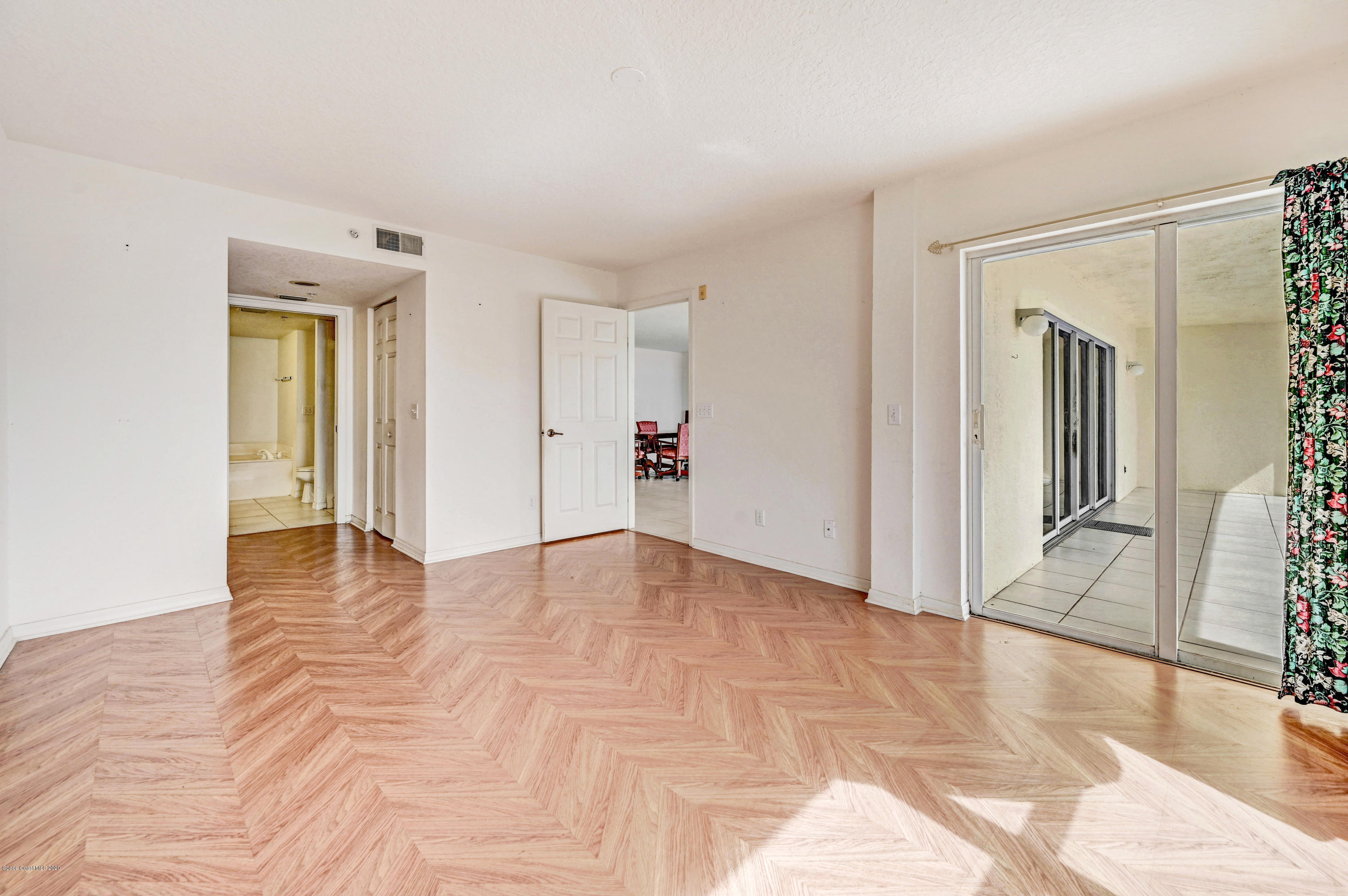 102 Riverside Drive, Unit 304 Cocoa, FL 32922 - Photo 16 of 49 a view of a livingroom with wooden floor and cabinet