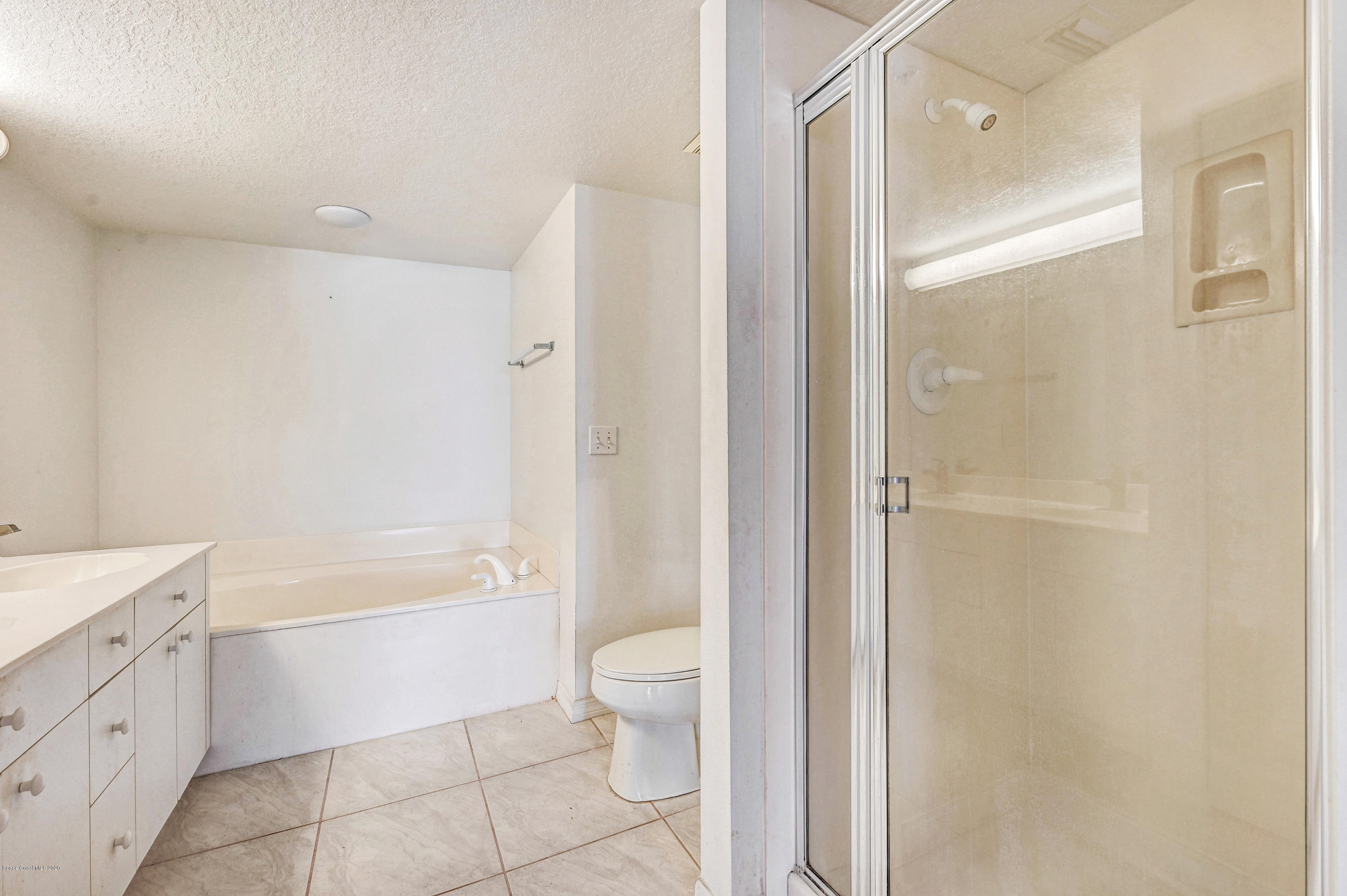 102 Riverside Drive, Unit 304 Cocoa, FL 32922 - Photo 18 of 49 a bathroom with a bathtub toilet and a shower
