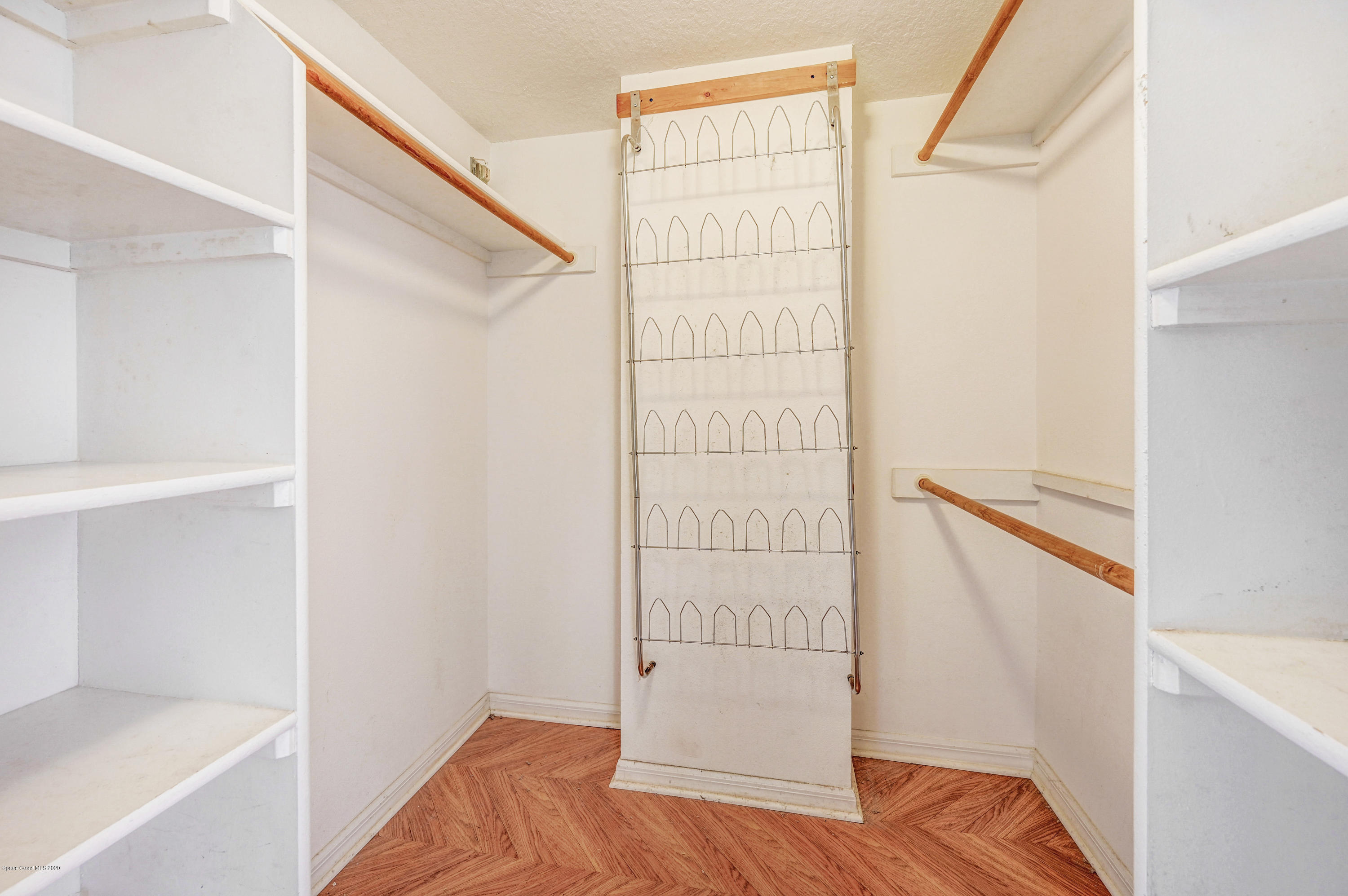 102 Riverside Drive, Unit 304 Cocoa, FL 32922 - Photo 19 of 49 a view of walk in closet with empty racks