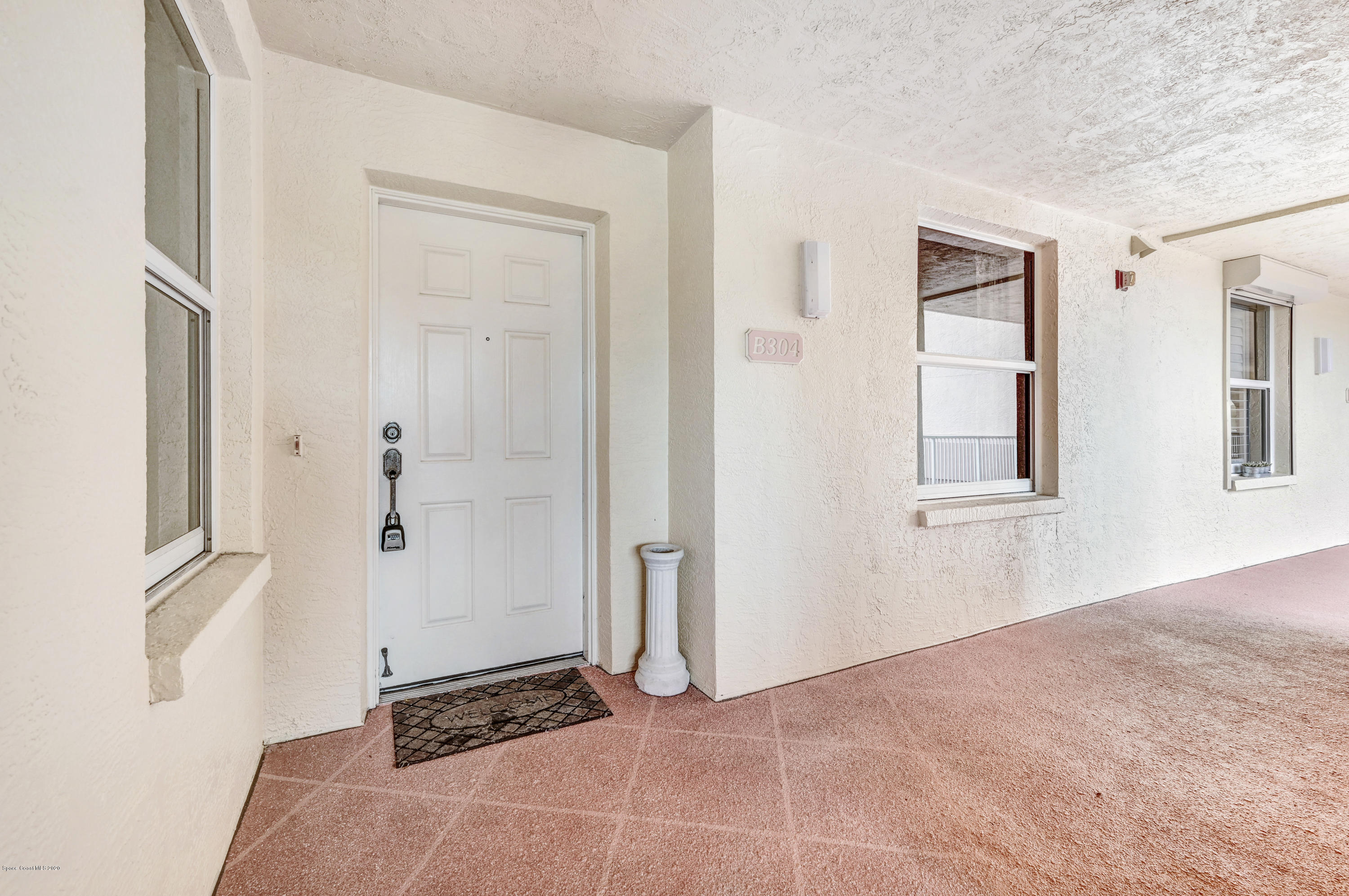 102 Riverside Drive, Unit 304 Cocoa, FL 32922 - Photo 28 of 49 a view of a bedroom with wooden floor and windows