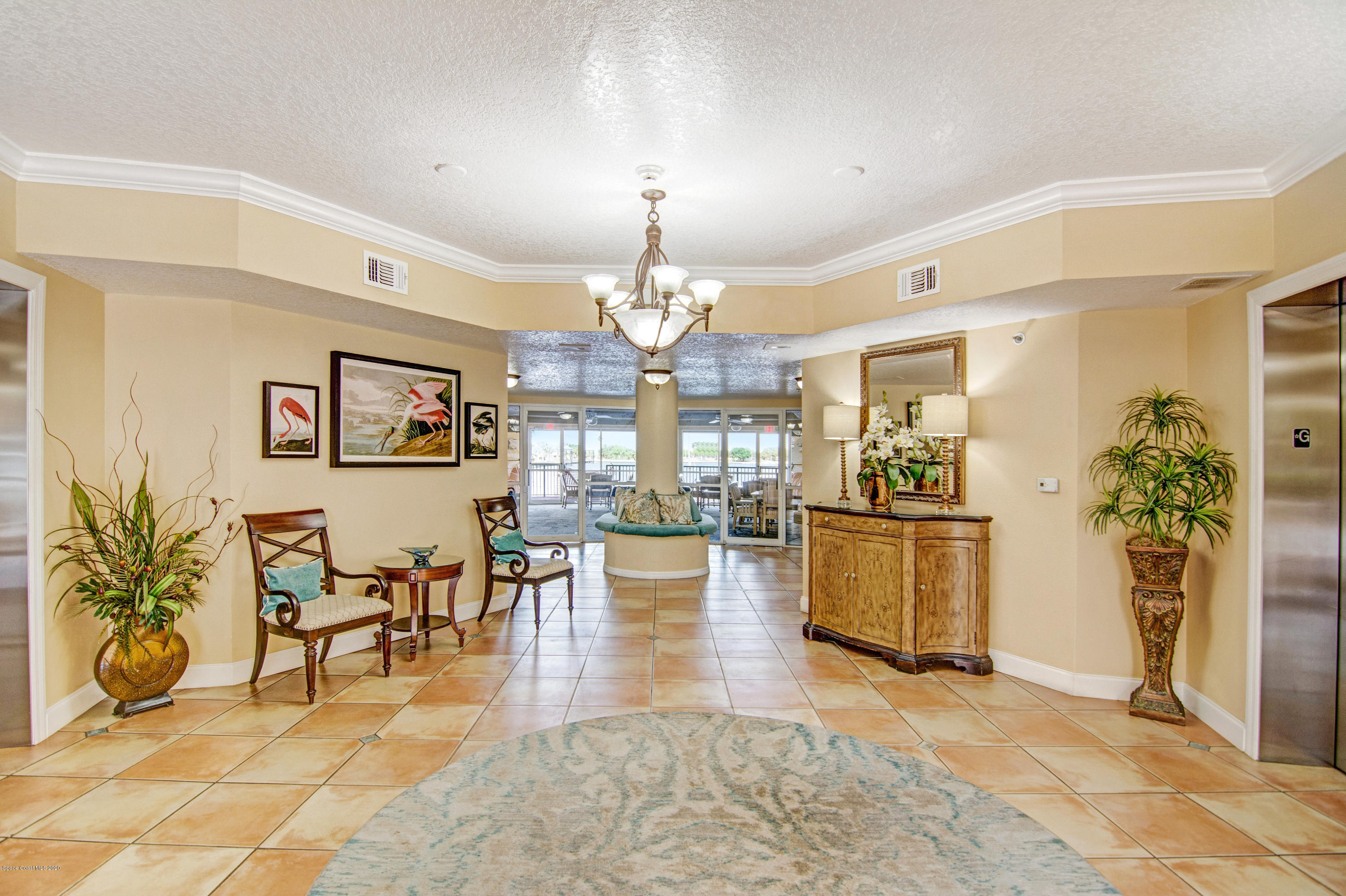 102 Riverside Drive, Unit 304 Cocoa, FL 32922 - Photo 31 of 49 a view of a dining room with furniture and a chandelier