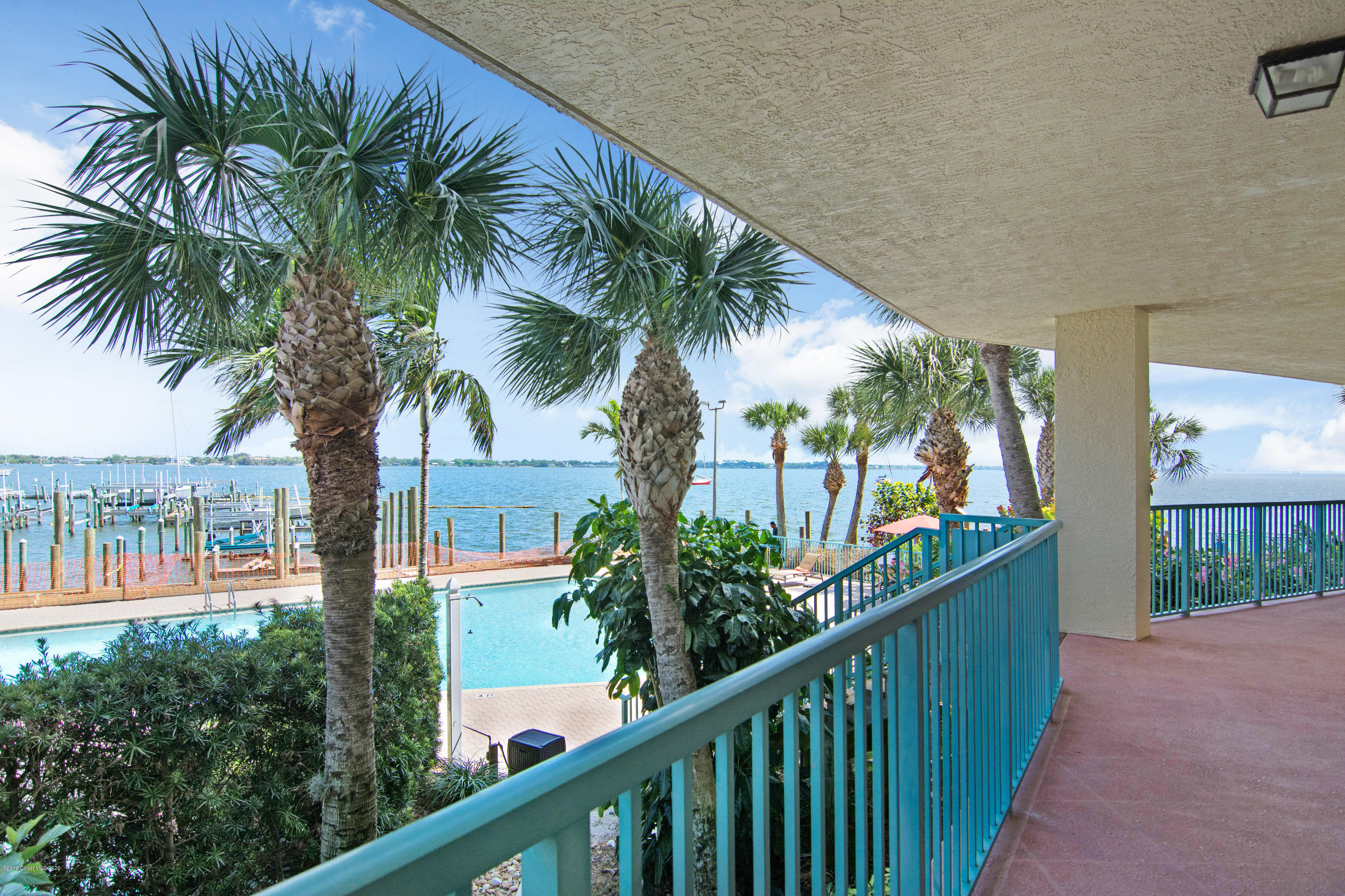 102 Riverside Drive, Unit 304 Cocoa, FL 32922 - Photo 33 of 49 a couple of palm trees in front of house