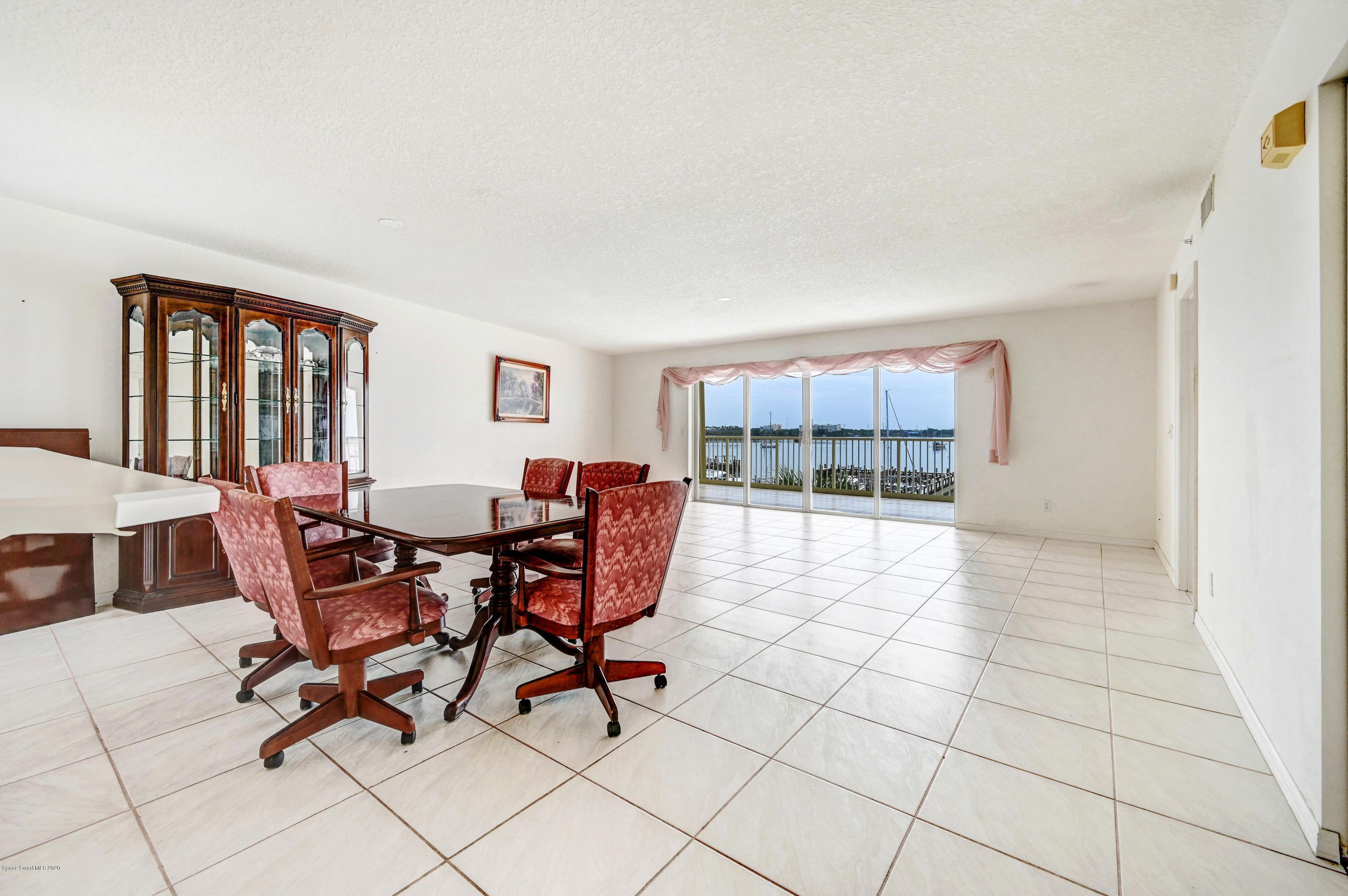 102 Riverside Drive, Unit 304 Cocoa, FL 32922 - Photo 6 of 49 a view of a dining room with furniture and a window