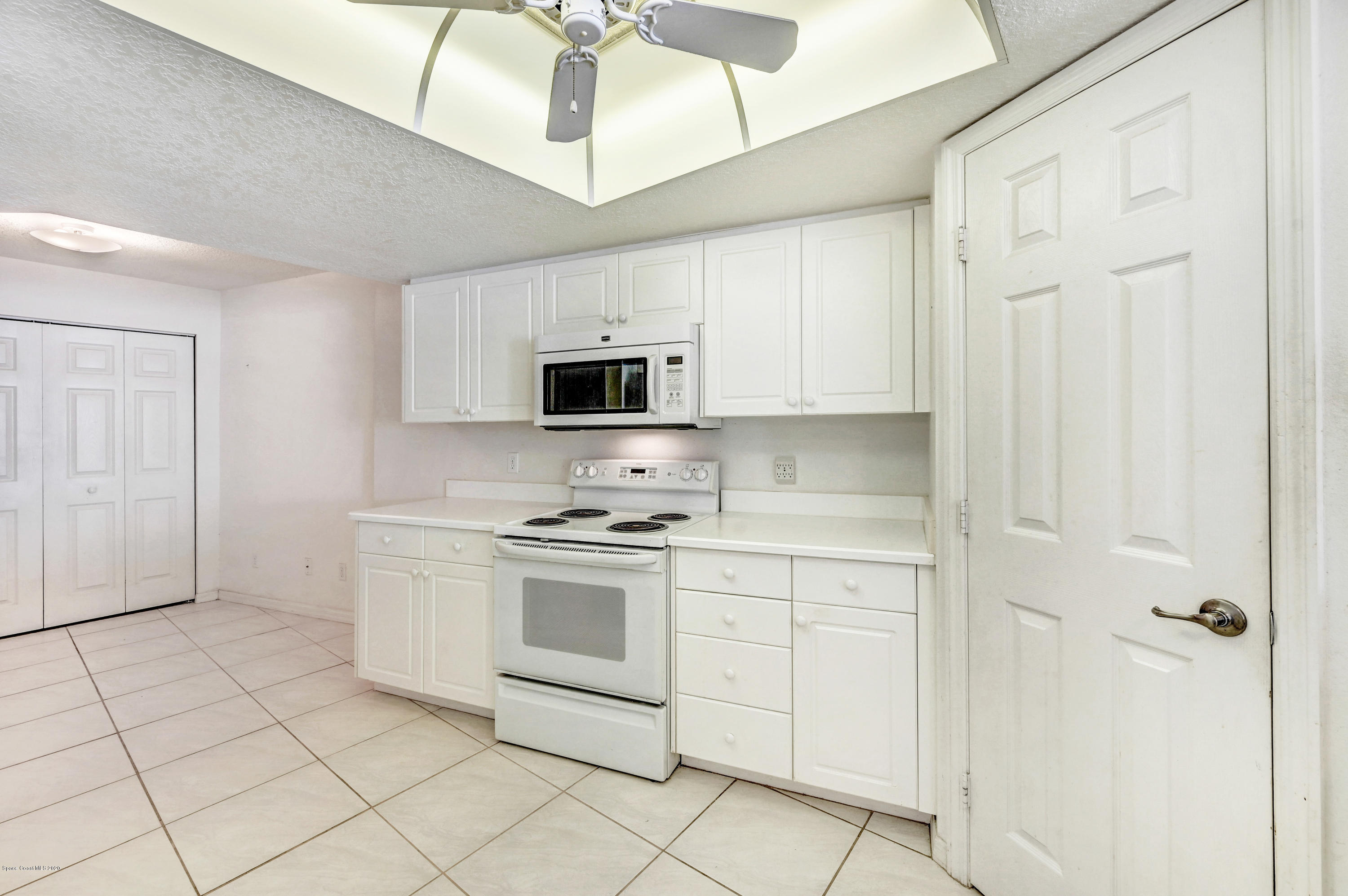 102 Riverside Drive, Unit 304 Cocoa, FL 32922 - Photo 8 of 49 a kitchen with stainless steel appliances granite countertop a stove a sink and a refrigerator