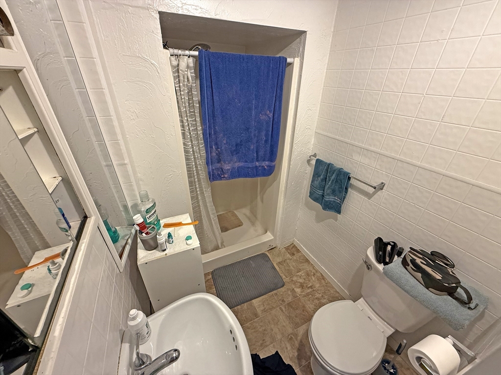 135-137 Temple Street Whitman, MA 02382 - Photo 15 of 15 a bathroom with a toilet a sink and a mirror