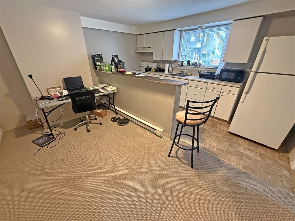 135-137 Temple Street Whitman, MA 02382 - Photo 8 of 15 a room with furniture a rug and white walls