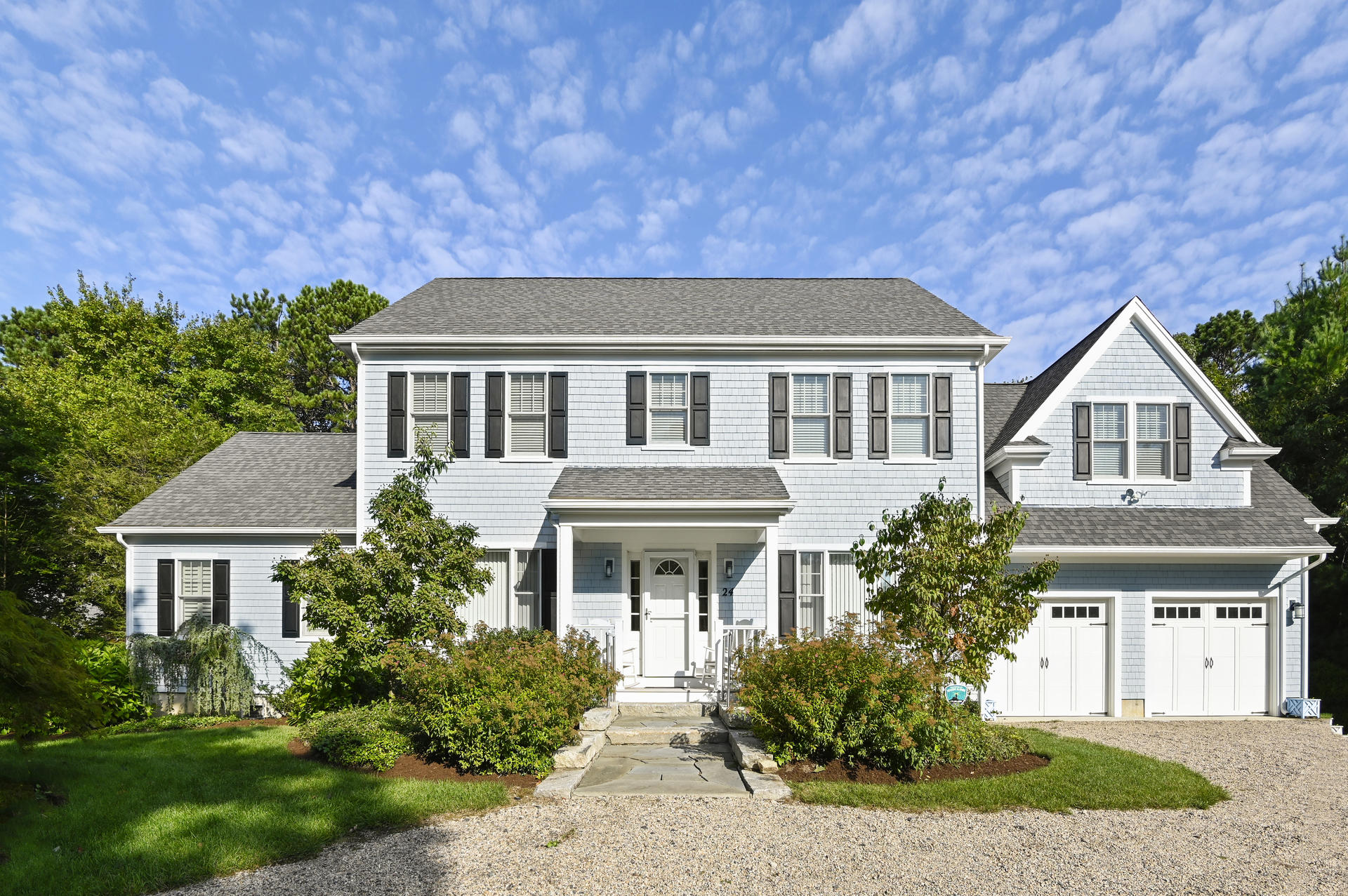 a front view of a house with garden