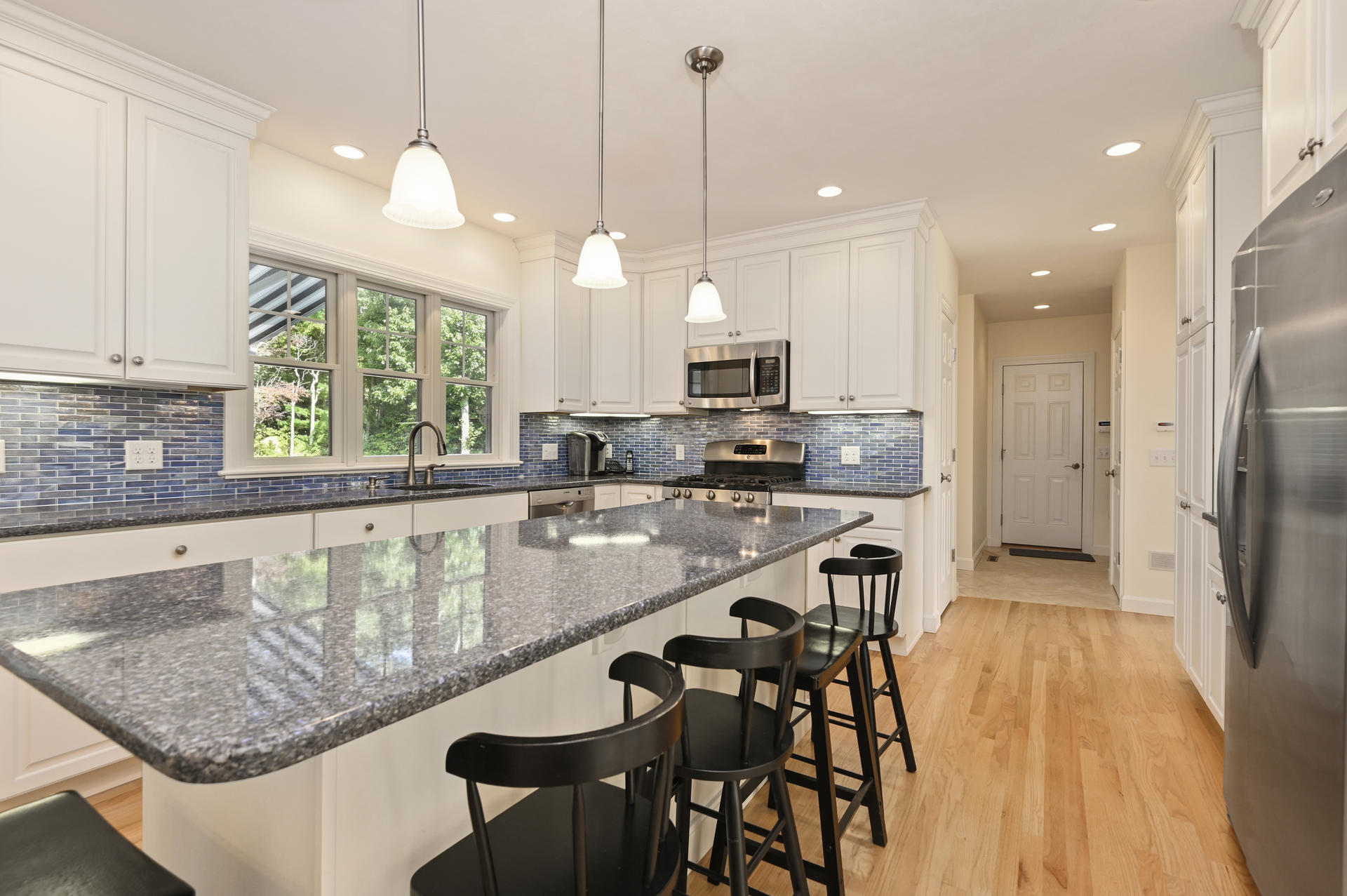 24 Pasture Road Cataumet, MA 02534 - Photo 5 of 24 a kitchen with kitchen island granite countertop a sink a counter top space appliances and cabinets
