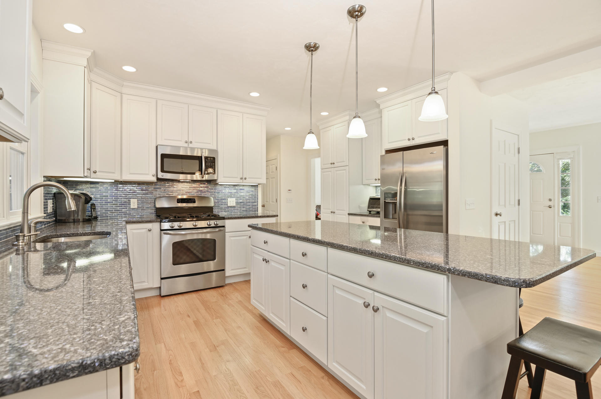 24 Pasture Road Cataumet, MA 02534 - Photo 6 of 24 a kitchen with stainless steel appliances a stove a sink a refrigerator a center island and cabinets