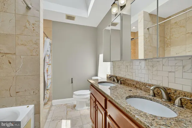 a bathroom with a bathtub and shower