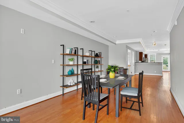 a dining room with furniture and wooden floor