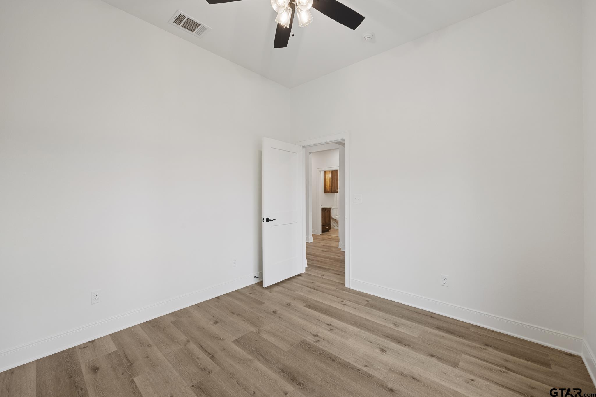 18778-c R 1100 C R 1100 Flint, TX 75762 - Photo 19 of 43 an empty room with a ceiling fan and wooden floor