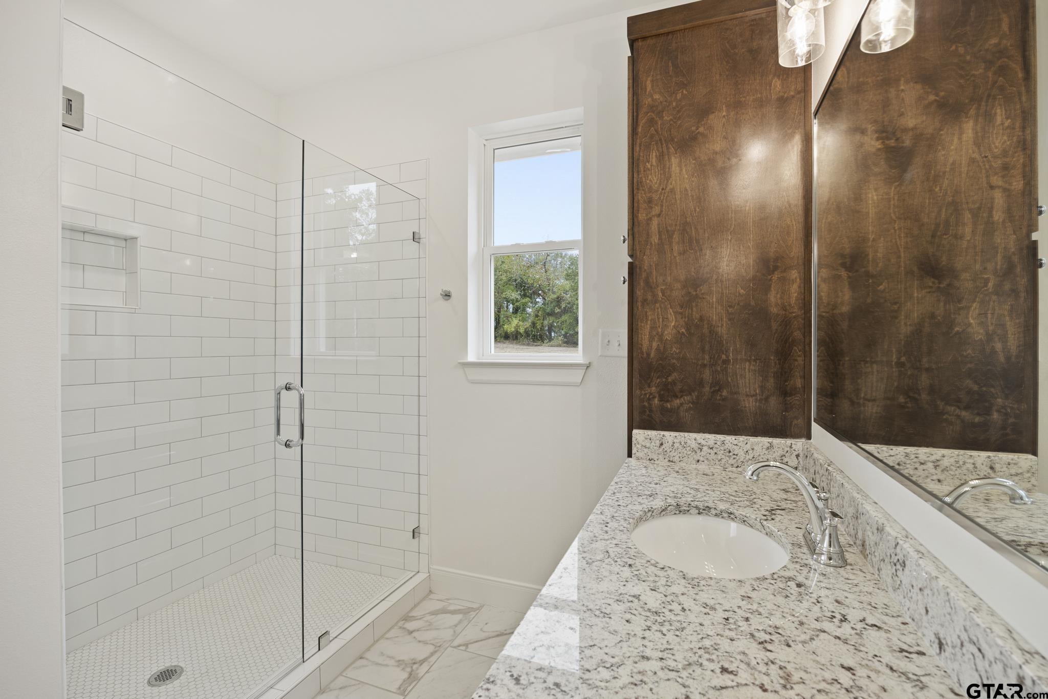 18778-c R 1100 C R 1100 Flint, TX 75762 - Photo 23 of 43 a bathroom with a granite countertop sink a shower and a mirror