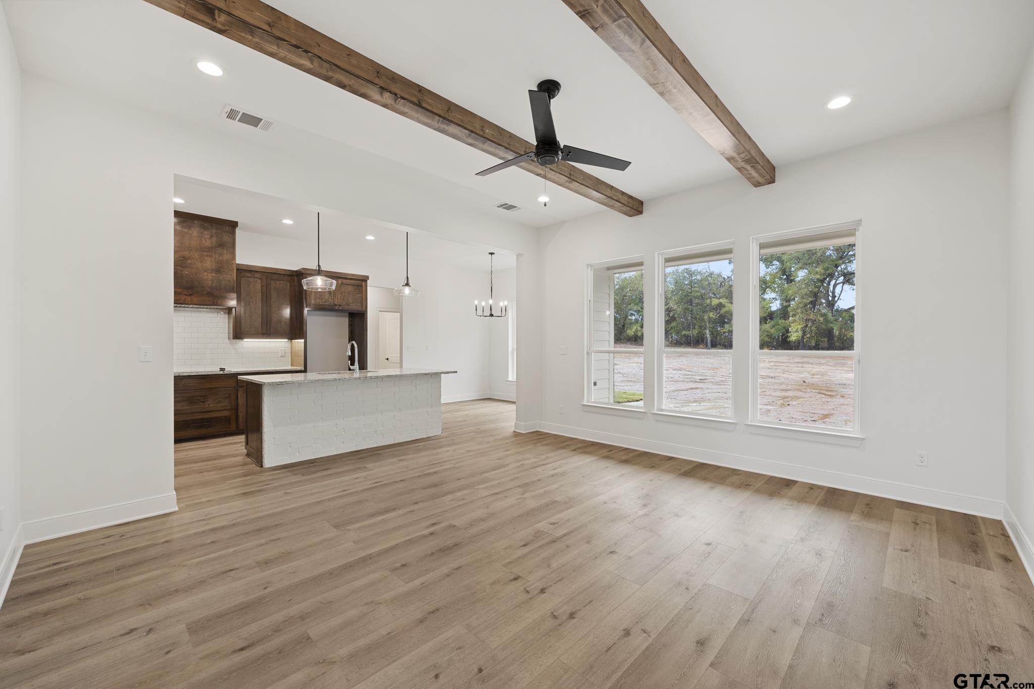 18778-c R 1100 C R 1100 Flint, TX 75762 - Photo 41 of 43 a view of a big room with wooden floor a ceiling fan and windows