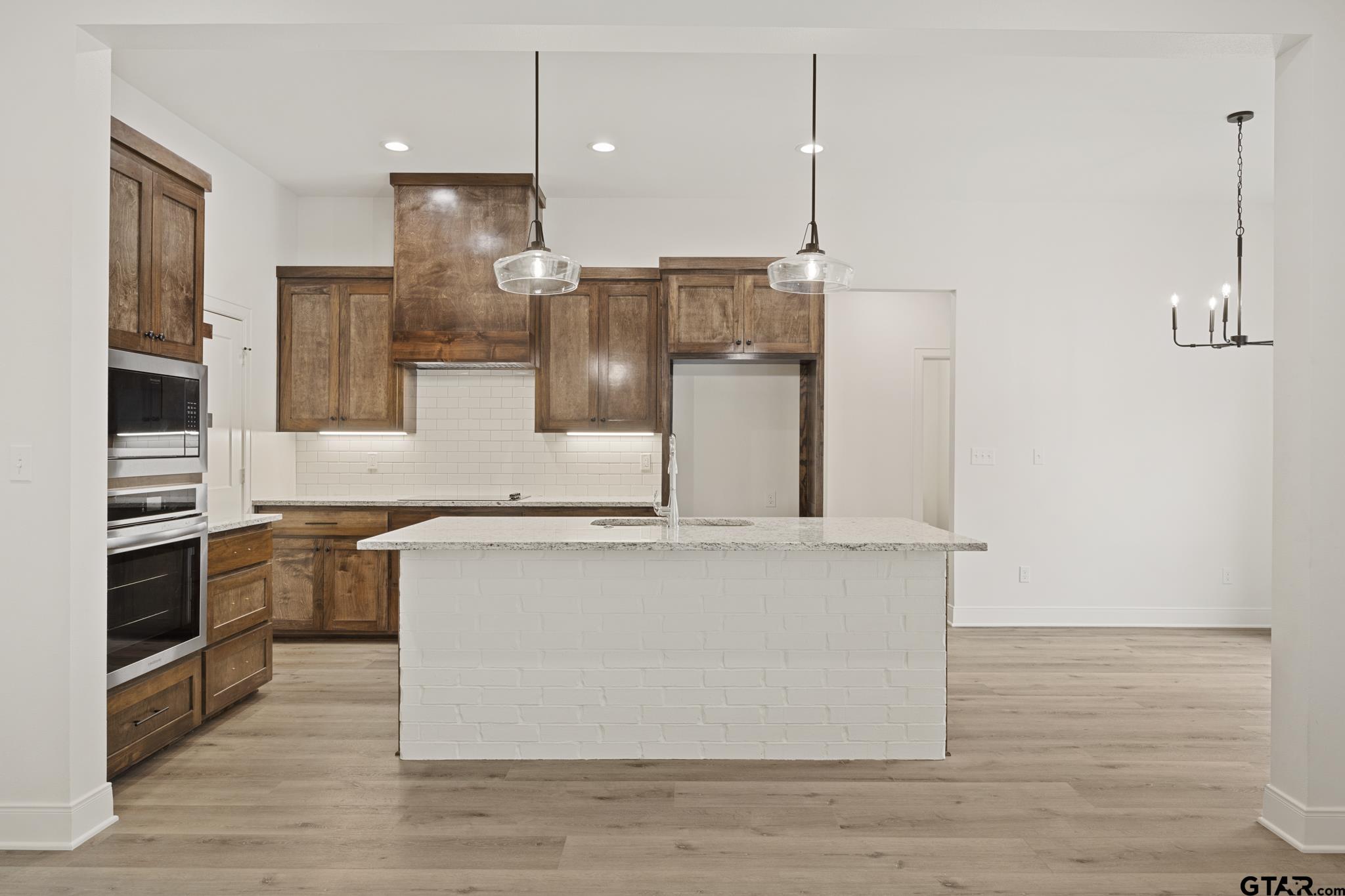 18778-c R 1100 C R 1100 Flint, TX 75762 - Photo 42 of 43 a kitchen with stainless steel appliances granite countertop a sink a stove and a wooden floor