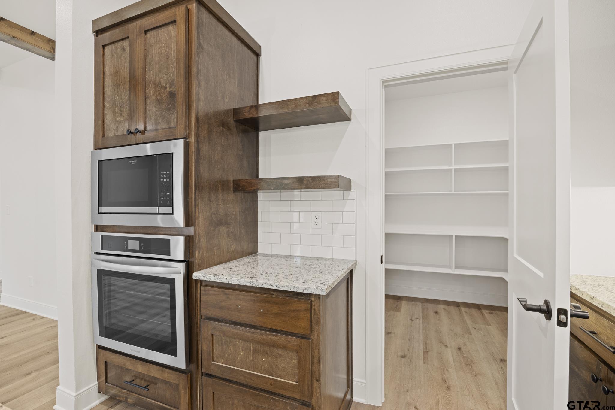 18778-c R 1100 C R 1100 Flint, TX 75762 - Photo 6 of 43 a kitchen with white cabinets and stainless steel appliances