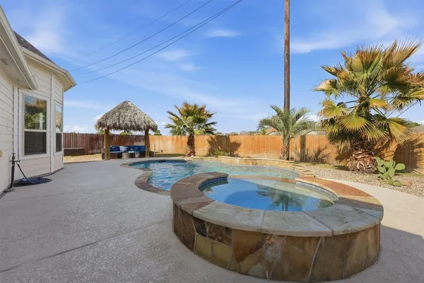 a view of a backyard with sitting area