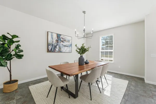 a kitchen with a sink a stove a refrigerator and white cabinets
