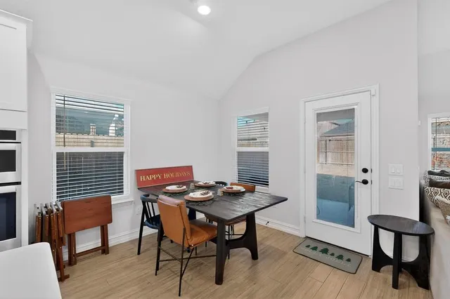 a view of a workspace with furniture and wooden floor