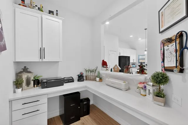 a kitchen with white cabinets and stainless steel appliances