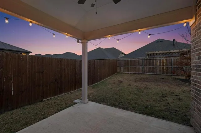 a view of backyard with wooden fence