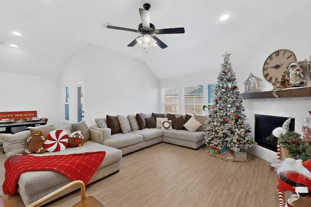 a living room with furniture potted plant and a fireplace