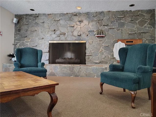 a living room with patio pool table and chairs with wooden floor