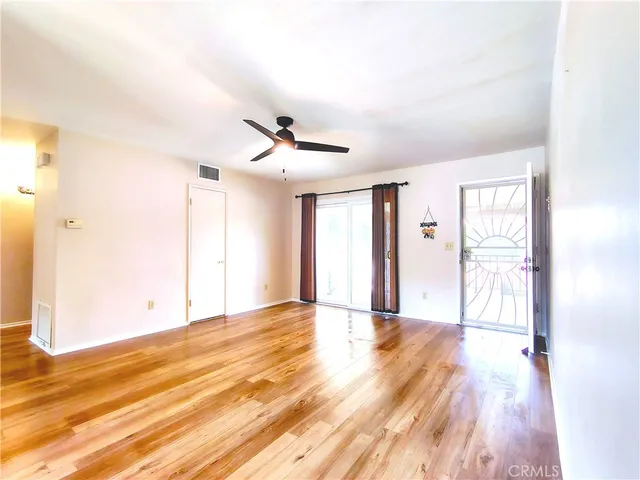 a kitchen with kitchen island granite countertop a refrigerator and a sink