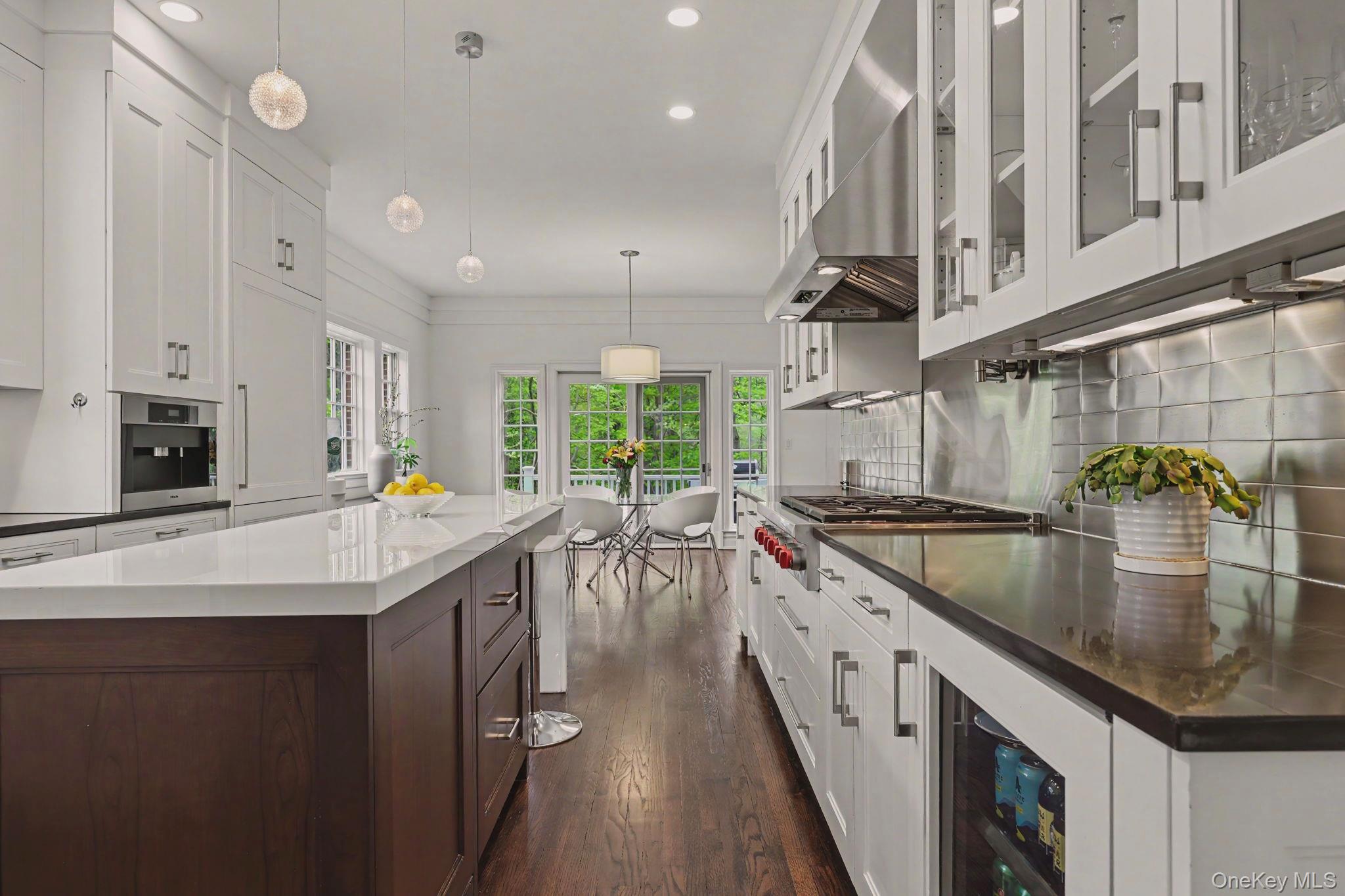 10 Morris Court Rye, NY 10580 - Photo 11 of 44 Kitchen with high end appliances 2 double ovens, 2 dishwashers, warming tray, beverage fridge, ice machine, Miele built-in coffee maker, walk-in pantry and breakfast nook opening on to deck through sliding doors