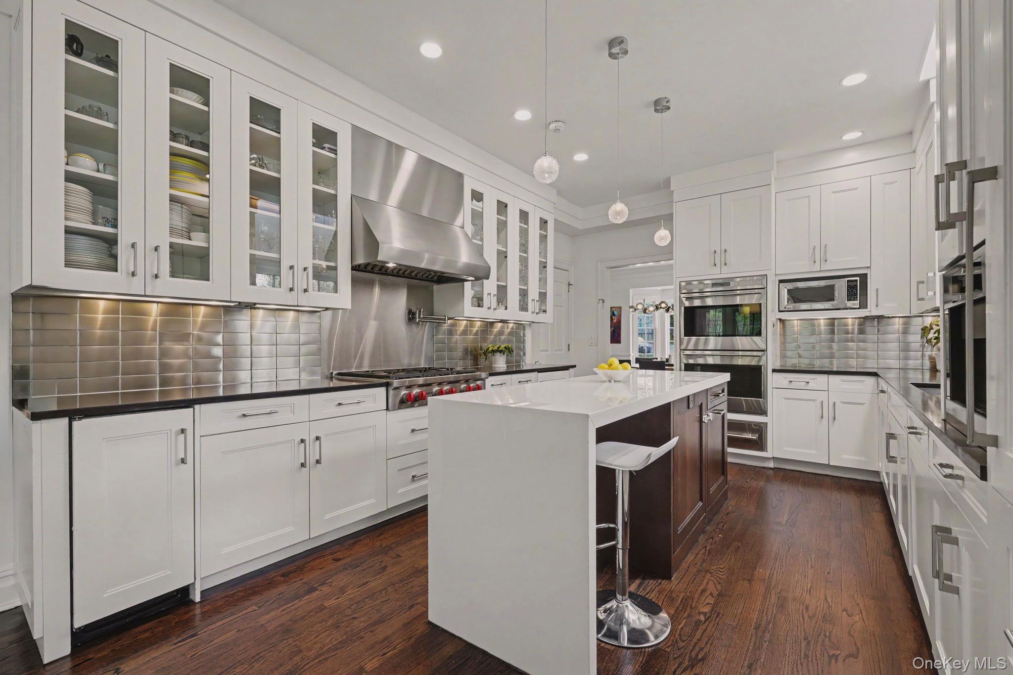 10 Morris Court Rye, NY 10580 - Photo 12 of 44 Kitchen with high end appliances 2 double ovens, 2 dishwashers, warming tray, beverage fridge, ice machine, Miele built-in coffee maker, walk-in pantry and breakfast nook opening on to deck through sliding doors