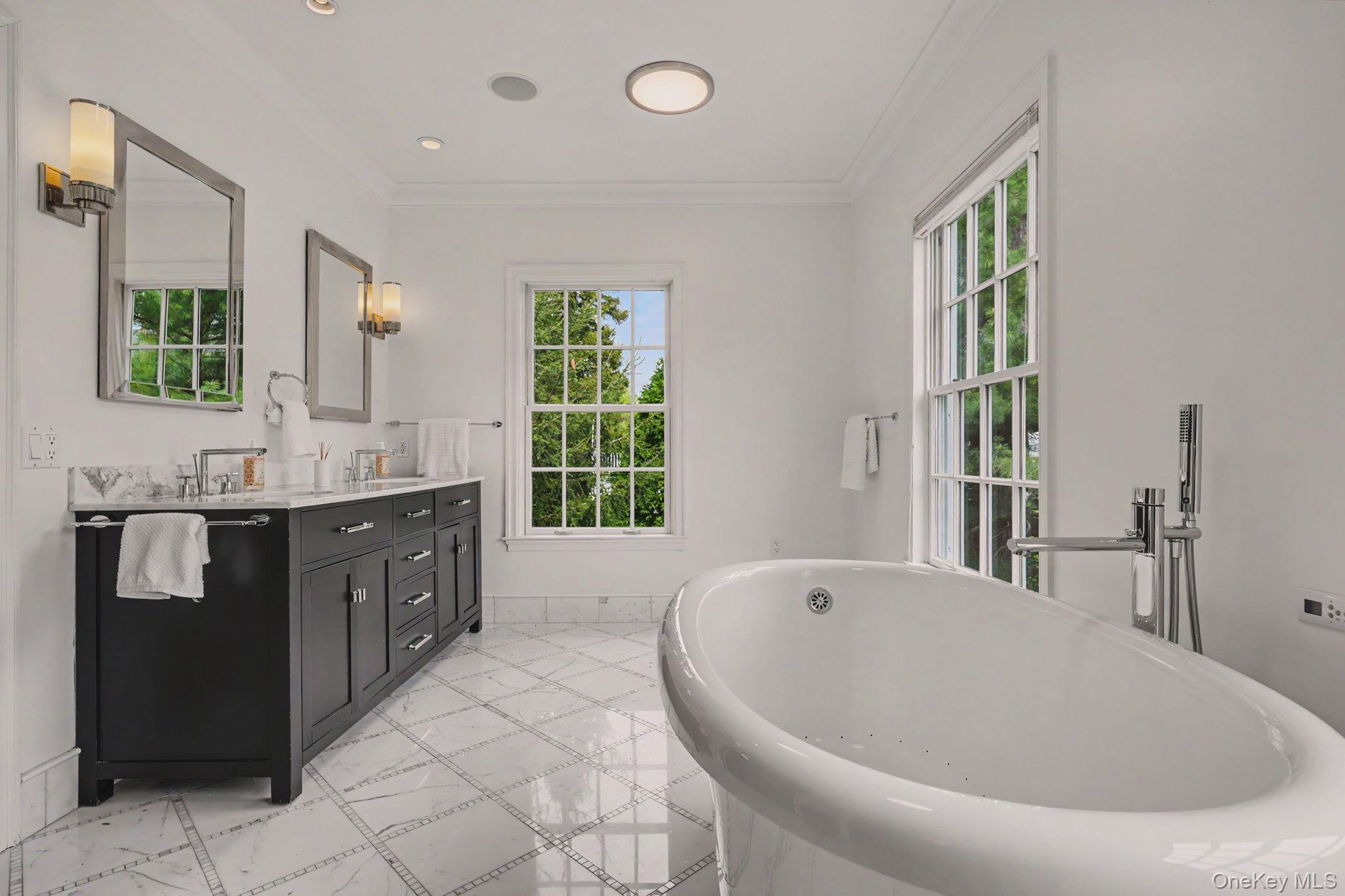 10 Morris Court Rye, NY 10580 - Photo 18 of 44 en-suite primary bathroom with soaking tub, double sinks, and walk-in shower
