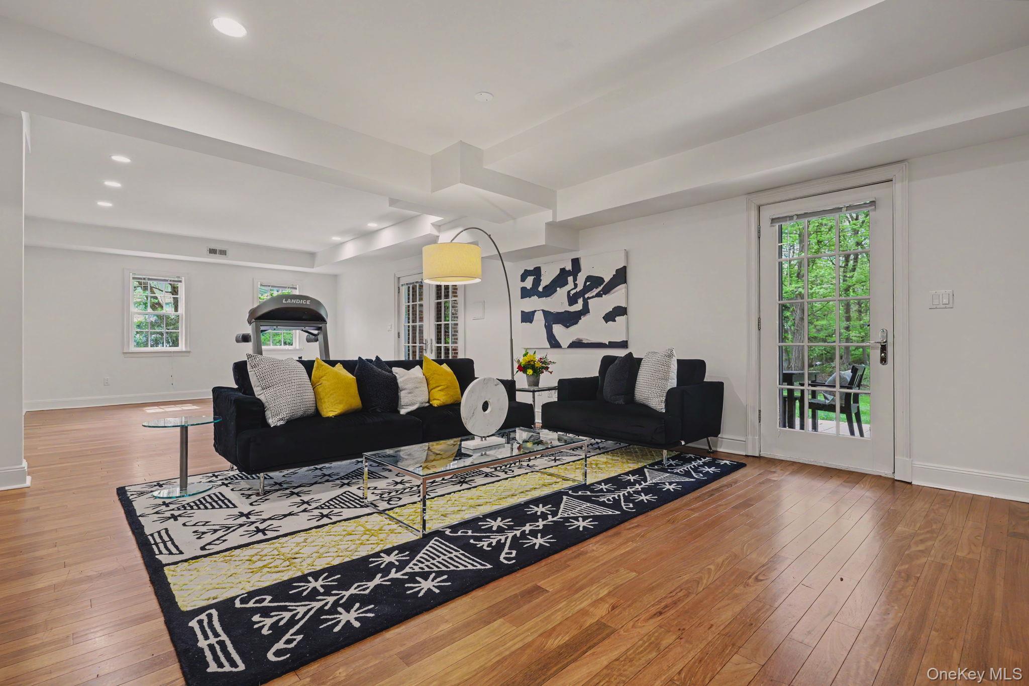10 Morris Court Rye, NY 10580 - Photo 27 of 44 Garden level family room, wet bar, gym area, with doors to patio and backyard