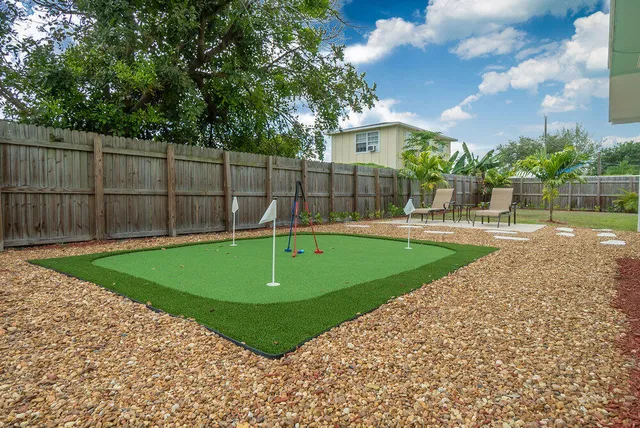 a kitchen with white cabinets sink and stainless steel appliances