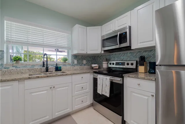 a kitchen with stainless steel appliances a refrigerator stove and microwave