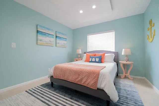 a bedroom with a bed and a lamp