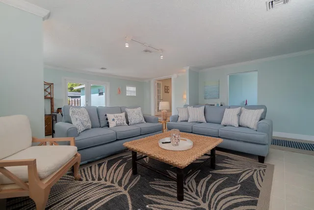 a living room with furniture and a dining table