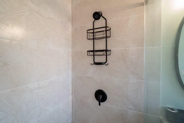 a bedroom with a bed and a lamp on the dresser