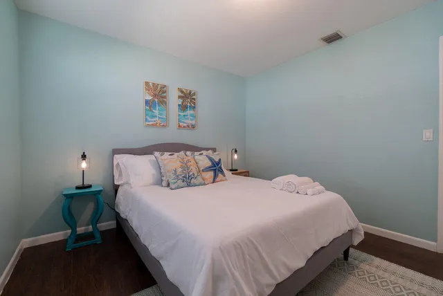 a room with a bed and a painting on the wall