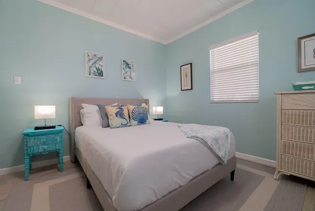 a room with a table and a painting on the wall