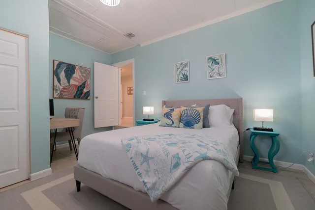 a bedroom with a bed and a lamp