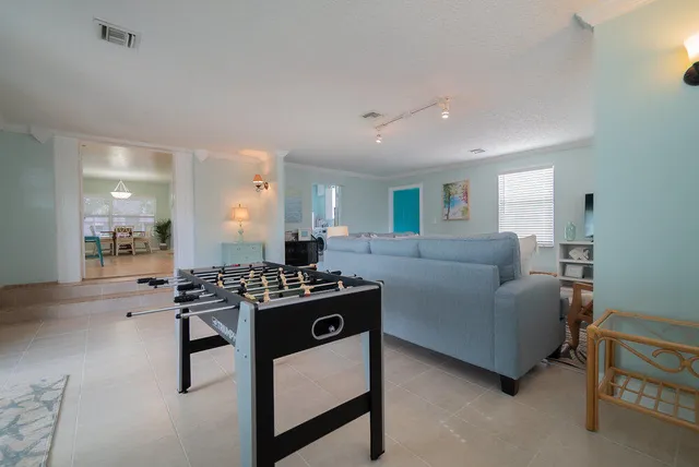 a living room with furniture and a floor to ceiling window