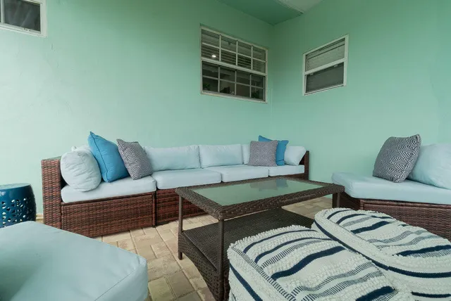 a backyard of a house with table and chairs