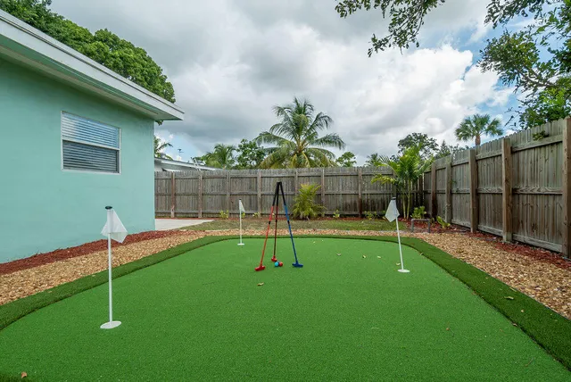 a view of a dining room with furniture a chandelier and wooden floor