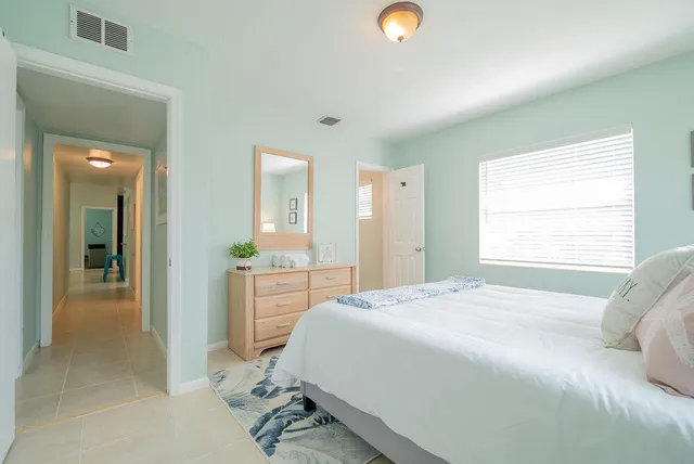 a bedroom with a bed and a dresser