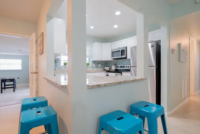 a kitchen with stainless steel appliances granite countertop a refrigerator and a sink