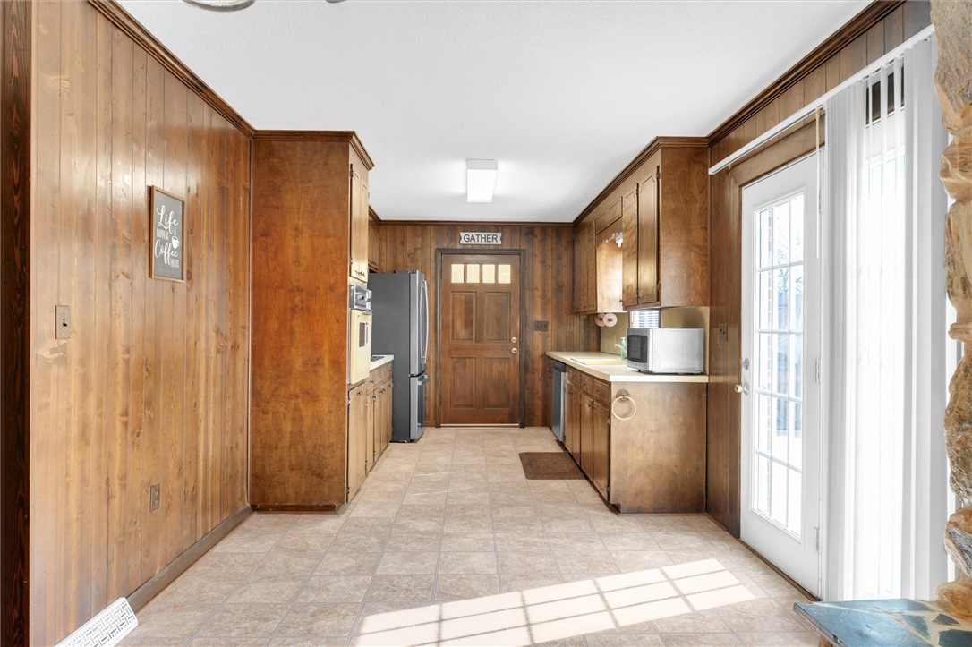 2114 Karen Lane Anderson, SC 29626 - Photo 11 of 30 This cozy kitchen features abundant wood paneling and cabinetry, creating a warm and inviting atmosphere.