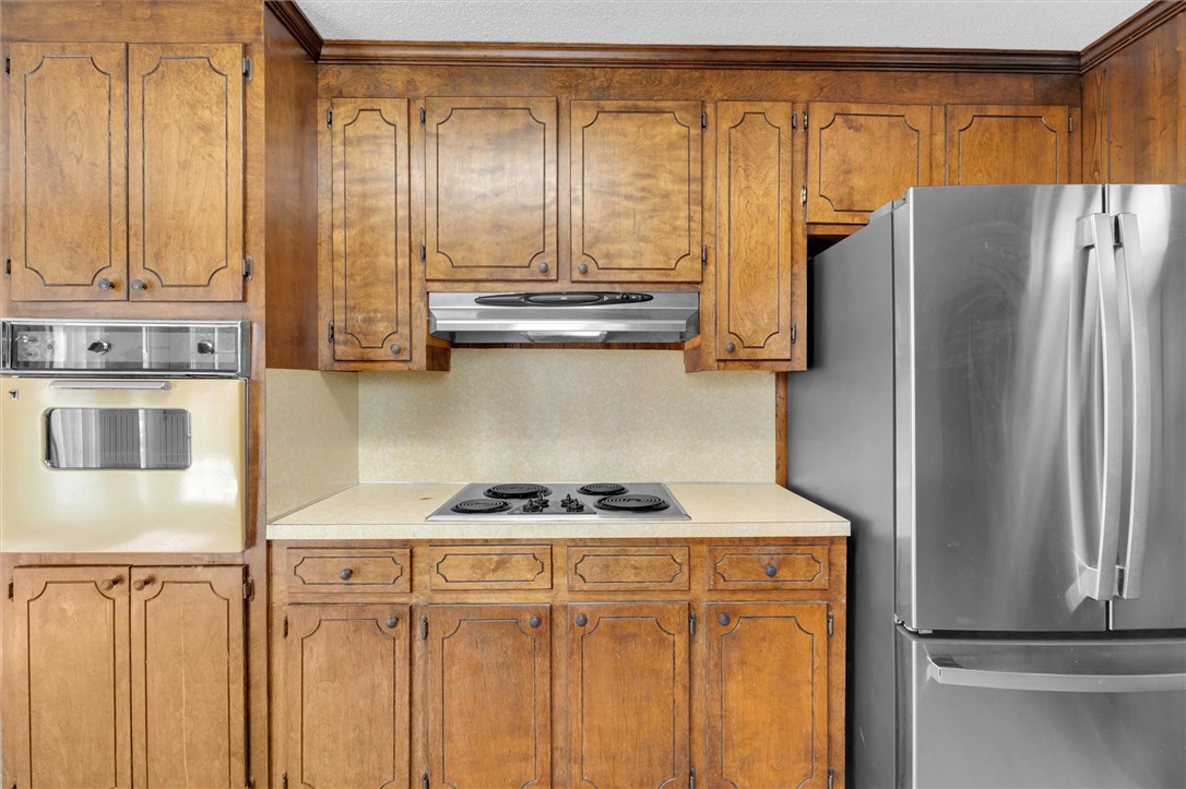 2114 Karen Lane Anderson, SC 29626 - Photo 15 of 30 This kitchen offers classic cabinetry, a built-in oven, and a modern refrigerator.